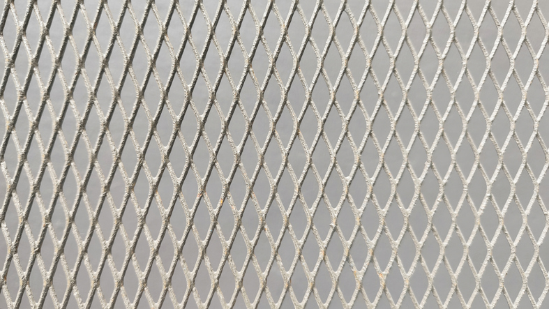 Close-up of expanded steel metal mesh texture, anodized finish, light grey color tone for background design.